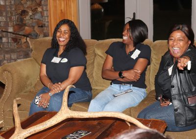 Three women laugh.